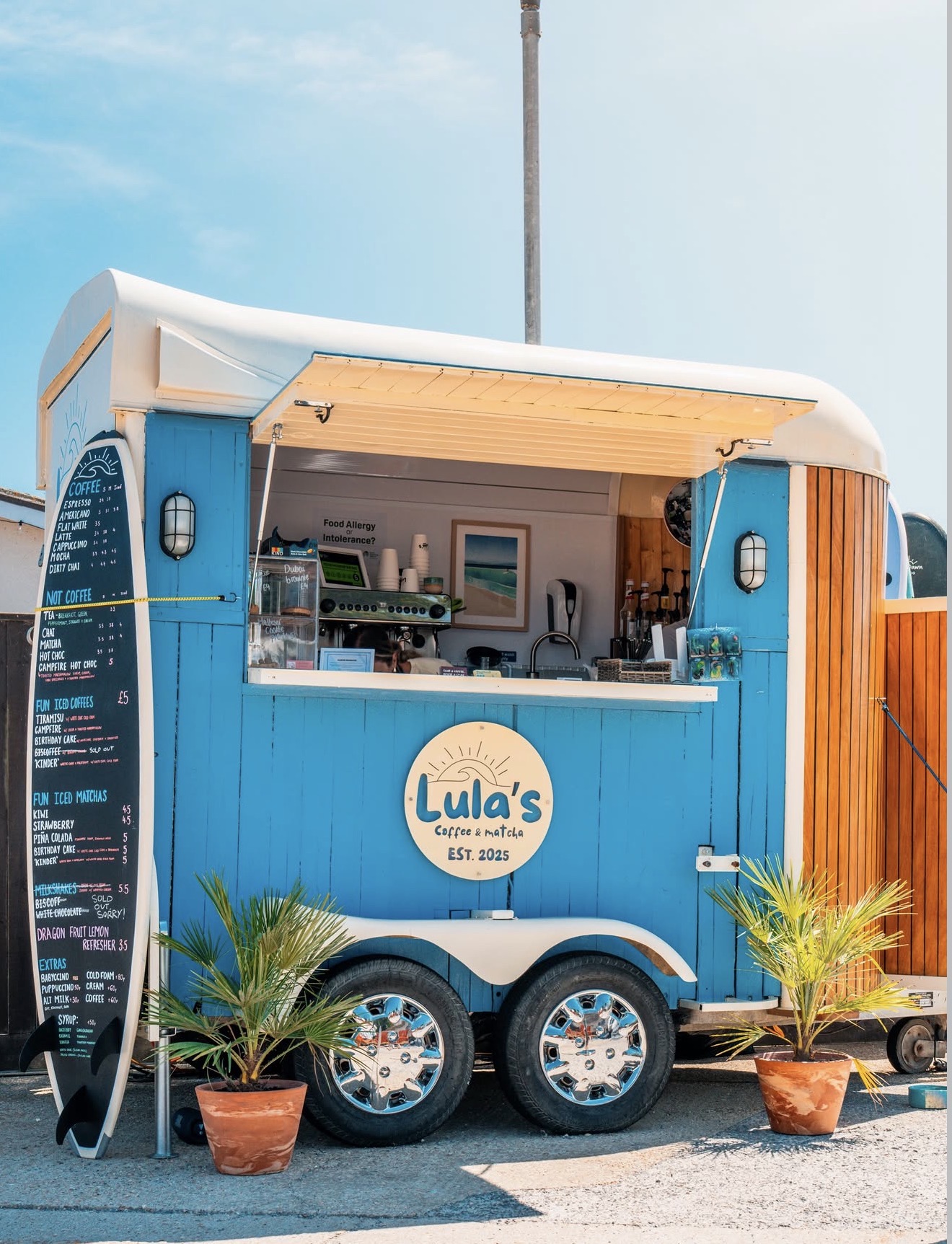 Lula's Coffee blue horse-box trailer parked at Elkins Boatyard on a sunny day